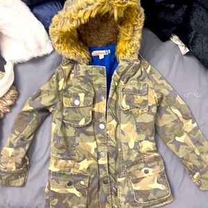 Camo  fleece lined utility jacket with tons of detail. Furry hood
